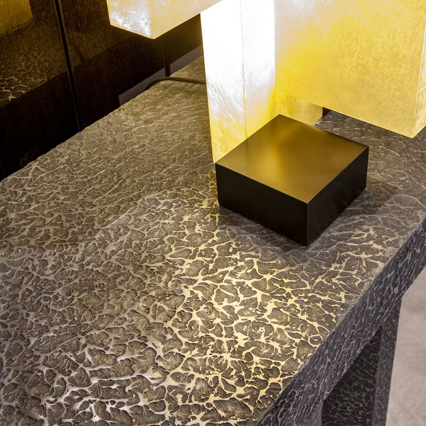 Imperfetto asymmetrical three-legged liquid metal tin console