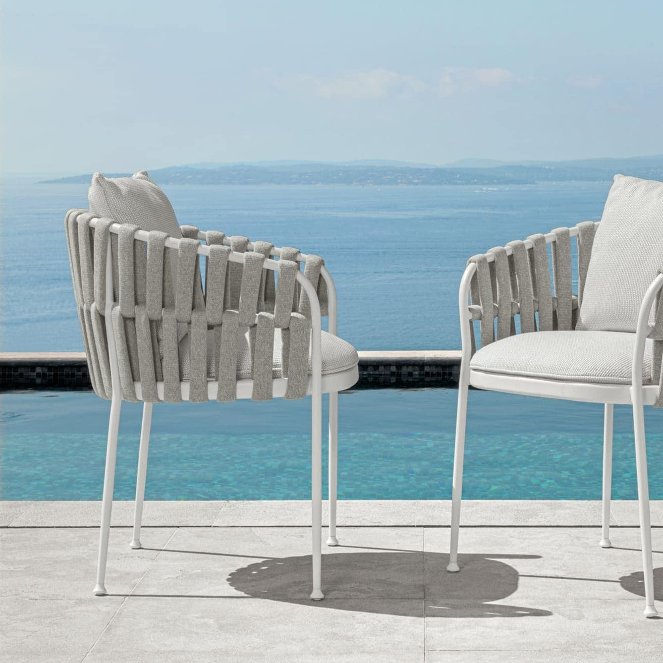 Outdoor armchairs with white fabric frame