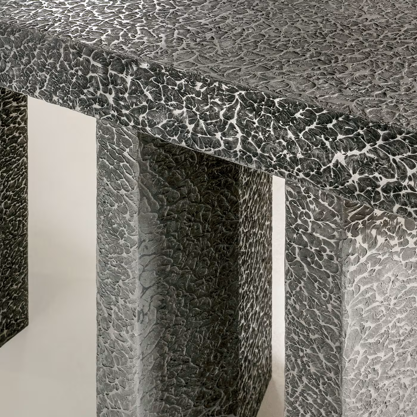 Imperfetto asymmetrical three-legged liquid metal tin console